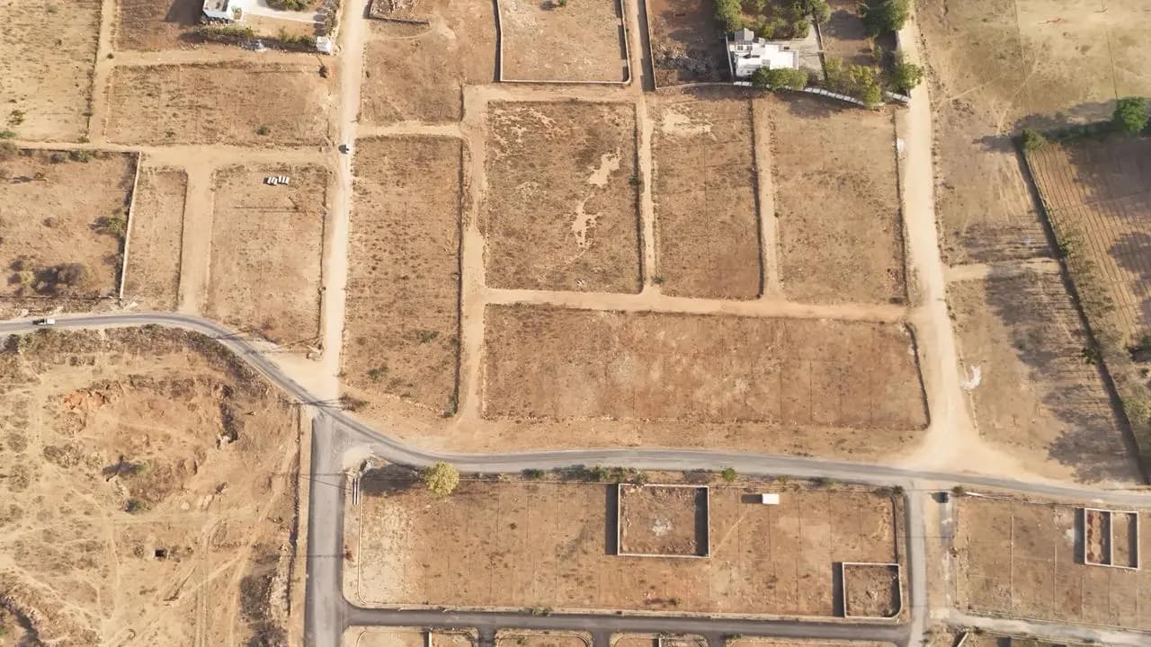 Aerial view of plotted land and a new development layout near Udaipur