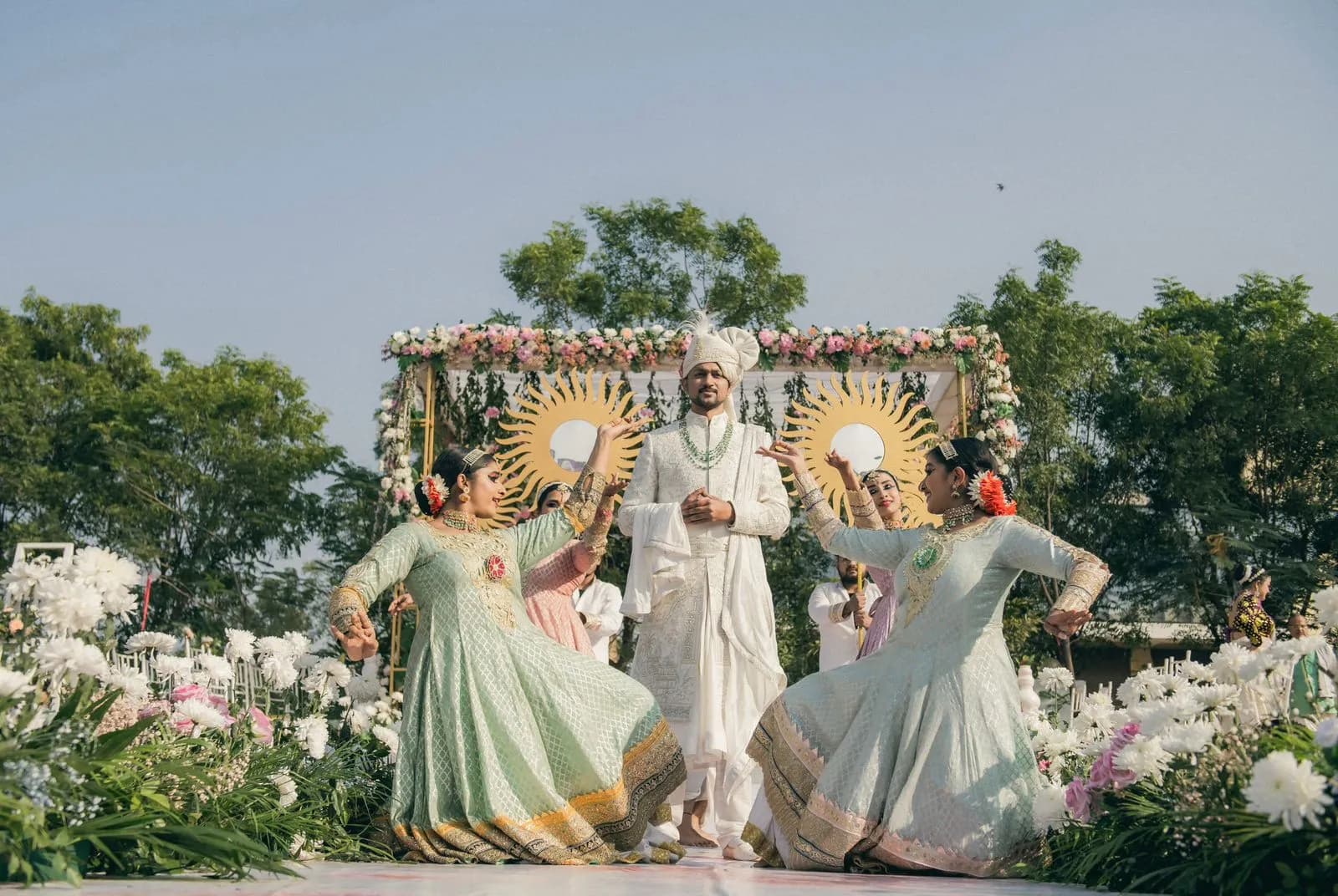 Wedding couple dancing on a floral stage in Udaipur