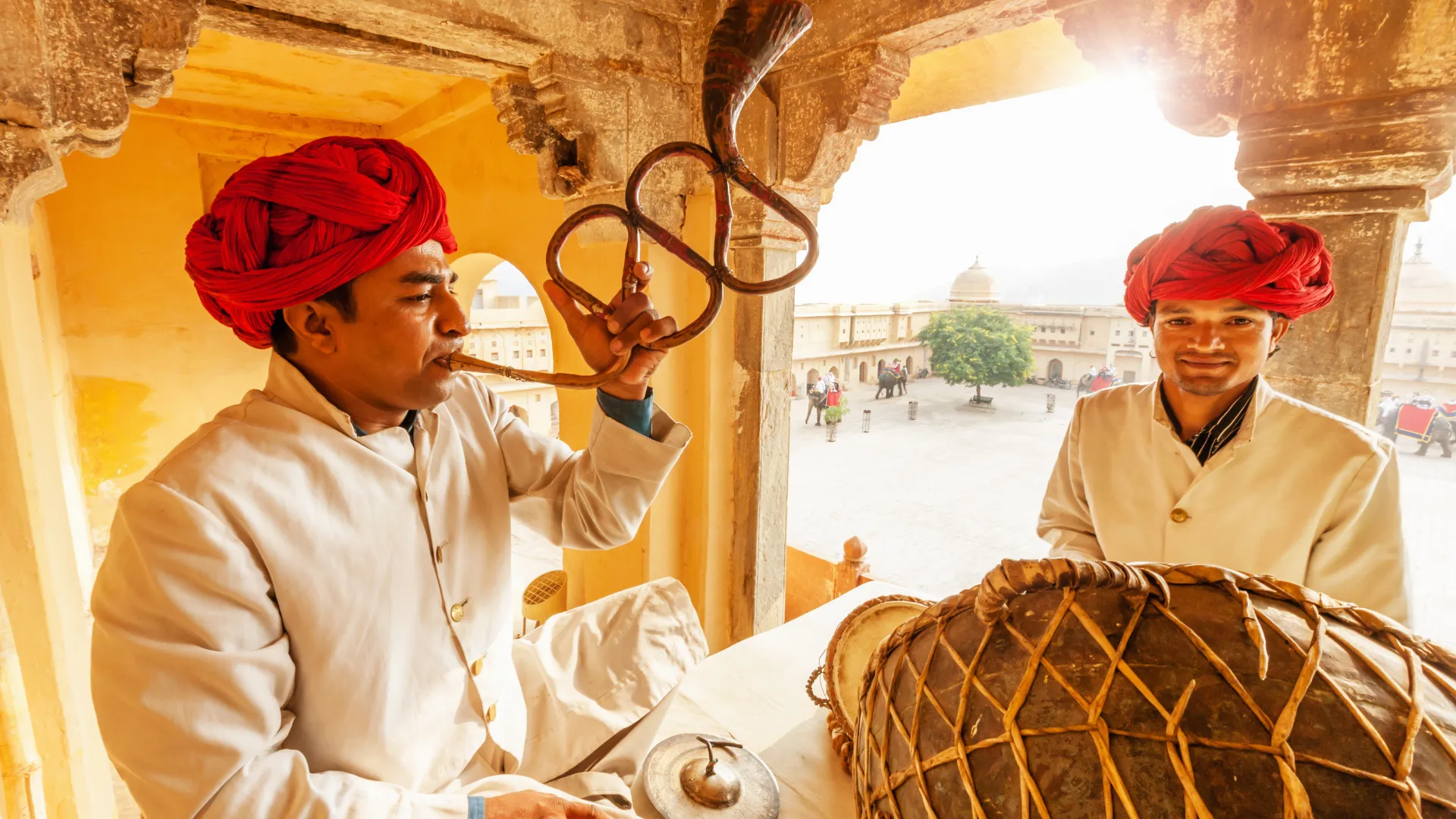 Folk musicians performing in a palace courtyard, like the evening Dharohar show